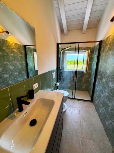a large bathroom with a sink and a shower at -La Bella Ameglia- Private Parking in Luni