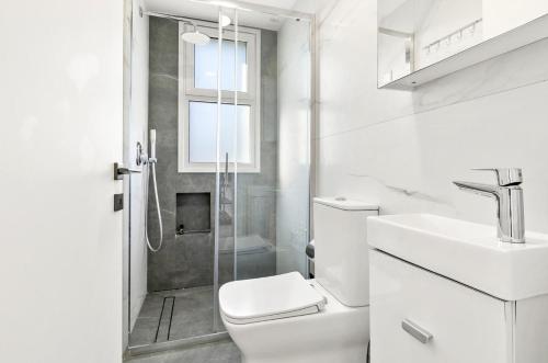 a bathroom with a toilet and a sink and a shower at STYLE°LIMASSOL in Limassol