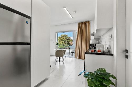 a kitchen and dining room with a view of a table at STYLE°LIMASSOL in Limassol
