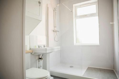 un bagno bianco con un water e un lavandino di Spaces Central House a Aylestone