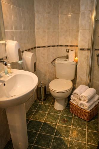 een badkamer met een wit toilet en een wastafel bij Хотел Ривърсайд Анекс in Bansko