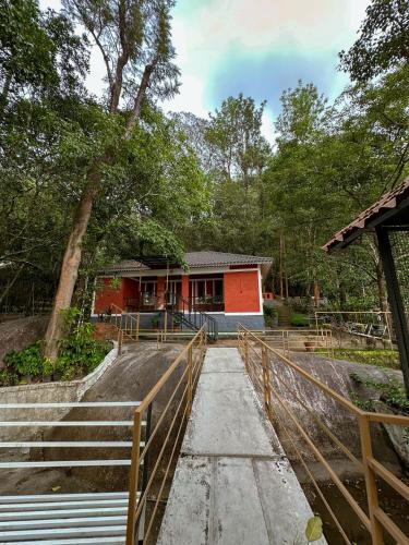 a house with a fence in front of it at Rockviewstay in Kalpetta