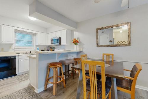 a kitchen and dining room with a table and chairs at Fort Morgan Townhomes E7 in Fort Morgan