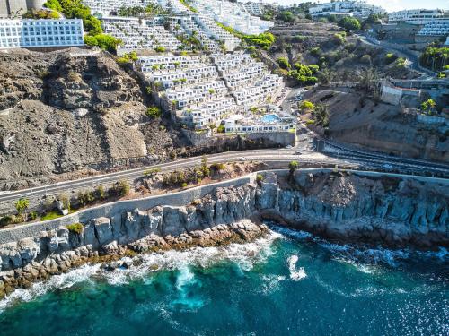 an aerial view of the ocean and buildings at Bahia Blanca in Puerto Rico de Gran Canaria