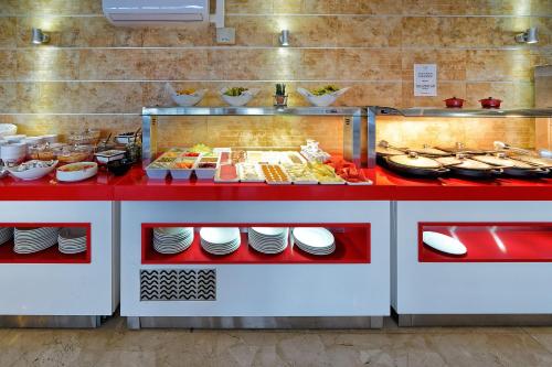 a buffet in a restaurant with plates and food at Bahia Blanca in Puerto Rico de Gran Canaria