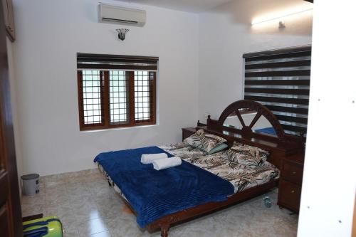 a bedroom with a bed with two pillows on it at White Haven in Angamaly