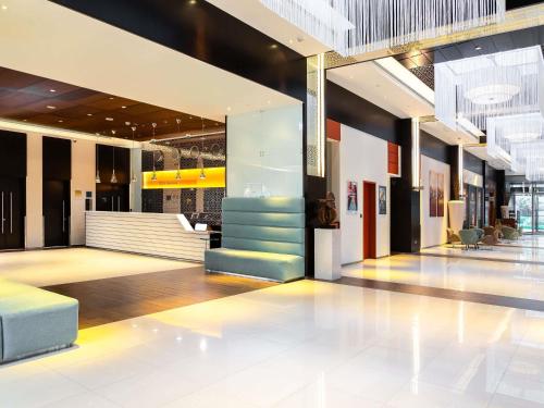 a lobby with a staircase in a building at ibis Dubai One Central in Dubai