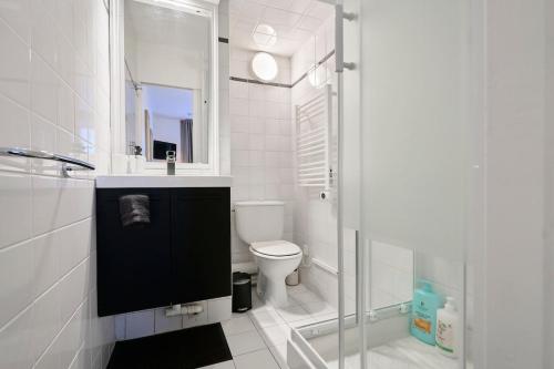 een witte badkamer met douche en toilet bij Studio Vauban, Lille in Lille