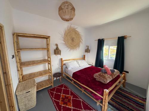 a bedroom with a bed and a ladder and a window at Atlantic refuge in Wassane