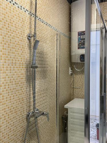 a shower in a bathroom with a tiled wall at Venetian Breeze in Mestre