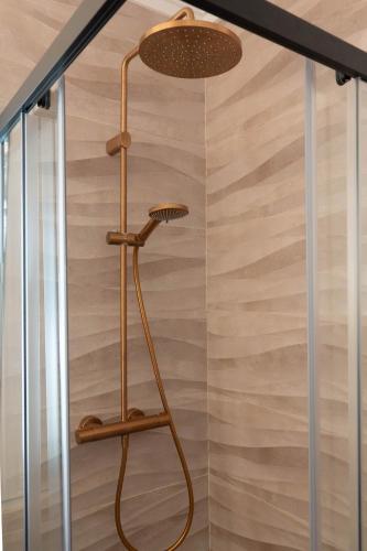 a shower in a bathroom with a glass door at Casa MaJa in Denia