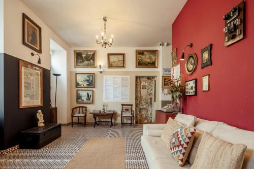 a living room with a red wall and a white couch at Labor Alliance Residence by LovelyStay in Lisbon