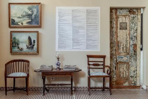 a room with two chairs and a table and a door at Labor Alliance Residence by LovelyStay in Lisbon