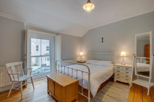a bedroom with a bed and a desk and a window at 2 Bed in Mumbles oc-hh1201 in The Mumbles