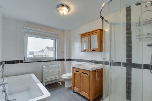 a bathroom with a toilet and a sink and a shower at 2 Bed in Mumbles oc-hh1201 in The Mumbles