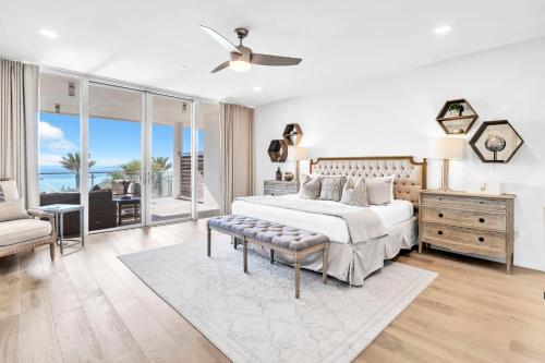 a white bedroom with a bed and a couch at Viridian 201 in Santa Rosa Beach
