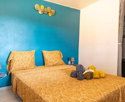 a bedroom with a bed with stuffed animals on it at Bel La Vi Apartment in Le Lamentin