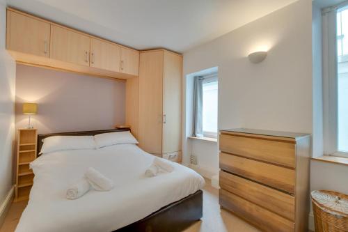 a bedroom with a large white bed and a window at 1 Bed in Mumbles oc-hh1205 in The Mumbles