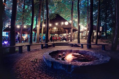 a fire pit in the middle of a park at night at Hotel Binkowski in Kielce