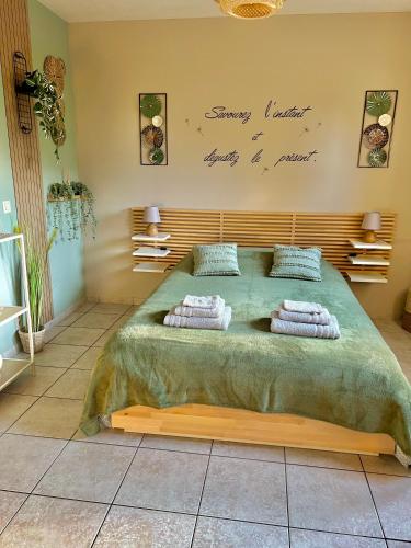 a bedroom with a large bed with pillows on it at Le refuge de Villeroux in Vaux-sur-Sûre