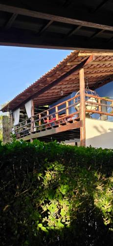 a balcony of a building with people sitting on it at Chalé Valen in Rio de Janeiro