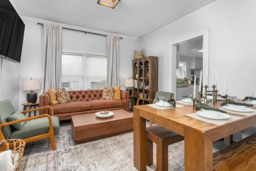 a living room with a table and a couch at Cozy 3BD with Air Hockey, BBQ - Near Duke University in Durham
