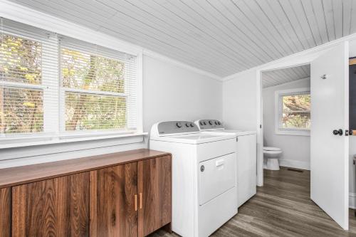a kitchen with a washing machine and a toilet at Cozy 3BD with Air Hockey, BBQ - Near Duke University in Durham