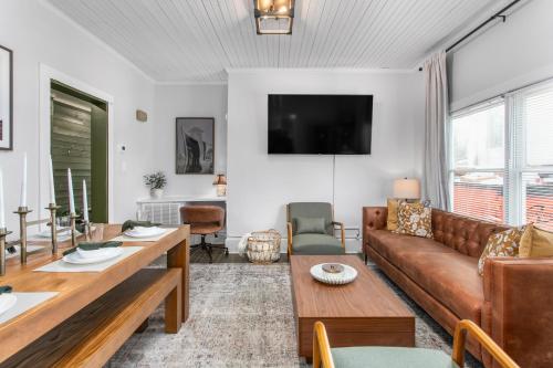a living room with a couch and a table at Cozy 3BD with Air Hockey, BBQ - Near Duke University in Durham