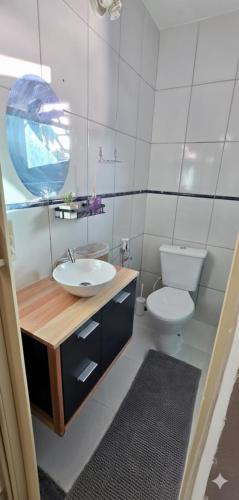 a bathroom with a sink and a toilet at Chalé Valen in Rio de Janeiro