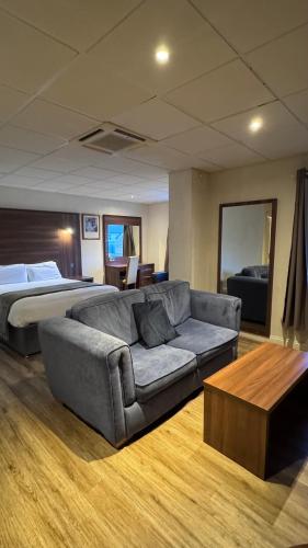a living room with a bed and a couch at The March Hotel in March