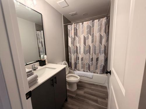 a bathroom with a sink and a toilet and a shower at Executive Comfort Suite in Weslaco