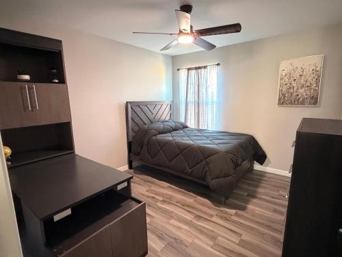a bedroom with a bed and a ceiling fan at Executive Comfort Suite in Weslaco