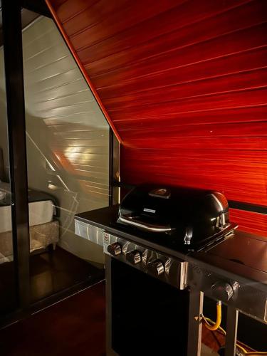 a kitchen with a stove with a pot on top of it at Cabaña El Encanto in El Porvenir