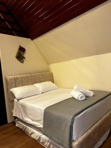 a bedroom with a bed with two towels on it at Cabaña El Encanto in El Porvenir