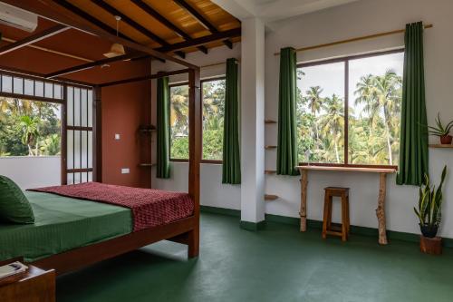 a bedroom with a bed and two windows at Ayana wellness resort in Talpe