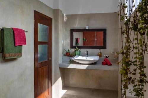 a bathroom with a sink and a mirror at Ayana wellness resort in Talpe