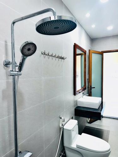 a bathroom with a shower and a toilet and a sink at Nutty Village Phu Quoc in Phú Quốc