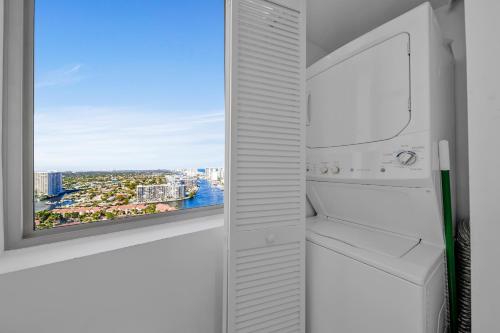 an empty refrigerator with a view of a city at Spacious Luxury Apartment at Beachwalk Resort with Ocean Views and Private Foyer in Hallandale Beach