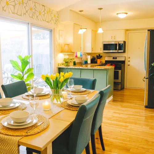 a kitchen and dining room with a table and chairs at SoCo Greenery Home for Long Stays with Spacious Fenced Yard & Ameniites in Austin
