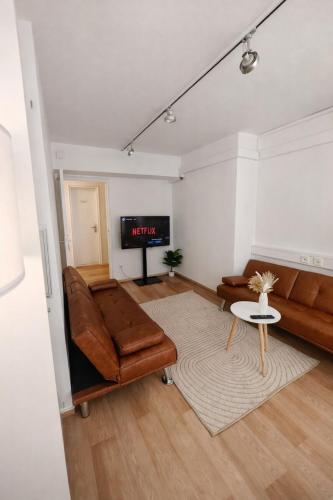 a living room with a couch and a table at Munich Premium Guesthouse-2 in Munich