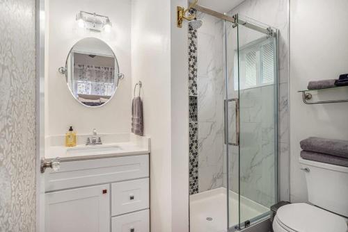 a bathroom with a shower and a sink and a mirror at Aspen Room in Berkeley