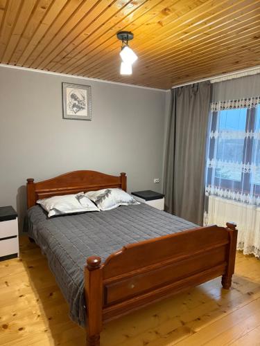 a bedroom with a bed and a wooden ceiling at Floris in Myta