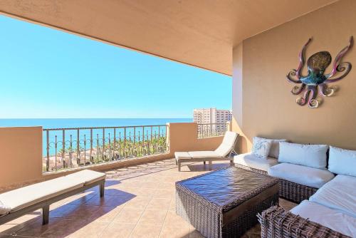 a living room with a couch and a view of the ocean at Bella Sirena Resort Premium View Condo in Puerto Peñasco