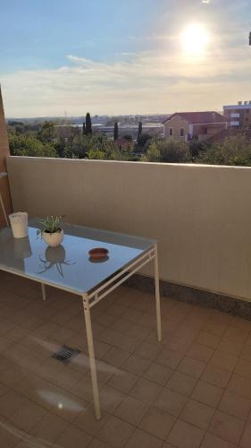 a table with a plant on top of a balcony at MINI House - 3 min dal GRA By followgreenhouserome in Rome