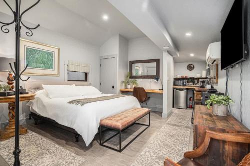 a bedroom with a large bed and a kitchen at Redwood Room in Berkeley