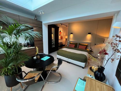 a bedroom with a bed and a table and chairs at B&B Urban Oasis with Free Parking in Amsterdam