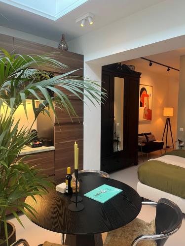 a room with a bed and a table and a bed at B&B Urban Oasis with Free Parking in Amsterdam