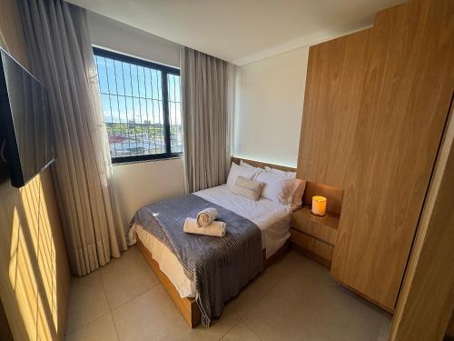 a hotel room with a bed with a tray on it at Estúdios Completos no Centro de Floripa - CMA in Florianópolis