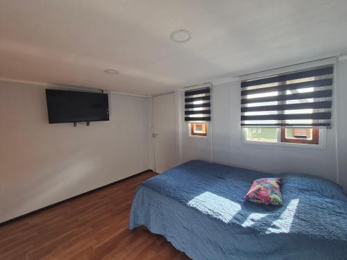 En eller flere senge i et værelse på Cabañas Friburgo