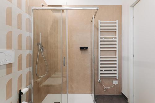 a shower with a glass door in a bathroom at Le camere in città in La Spezia